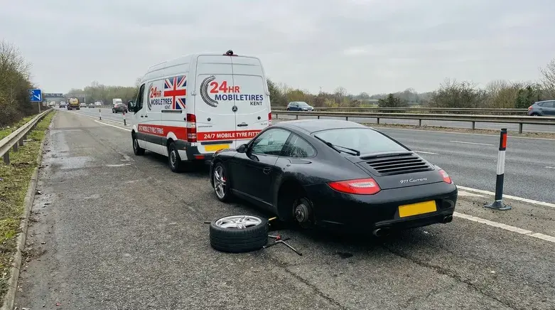 Mobile tyre fitting Folkestone service replacing flat car tyre on motorway roadside with 24hr mobile tyre fitting van
